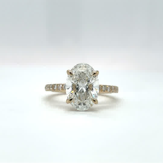 14K yellow gold engagement ring with a 3.04ct D VS1 IGI Oval lab grown diamond and 0.45cttw oval lab grown diamonds E-F VS1